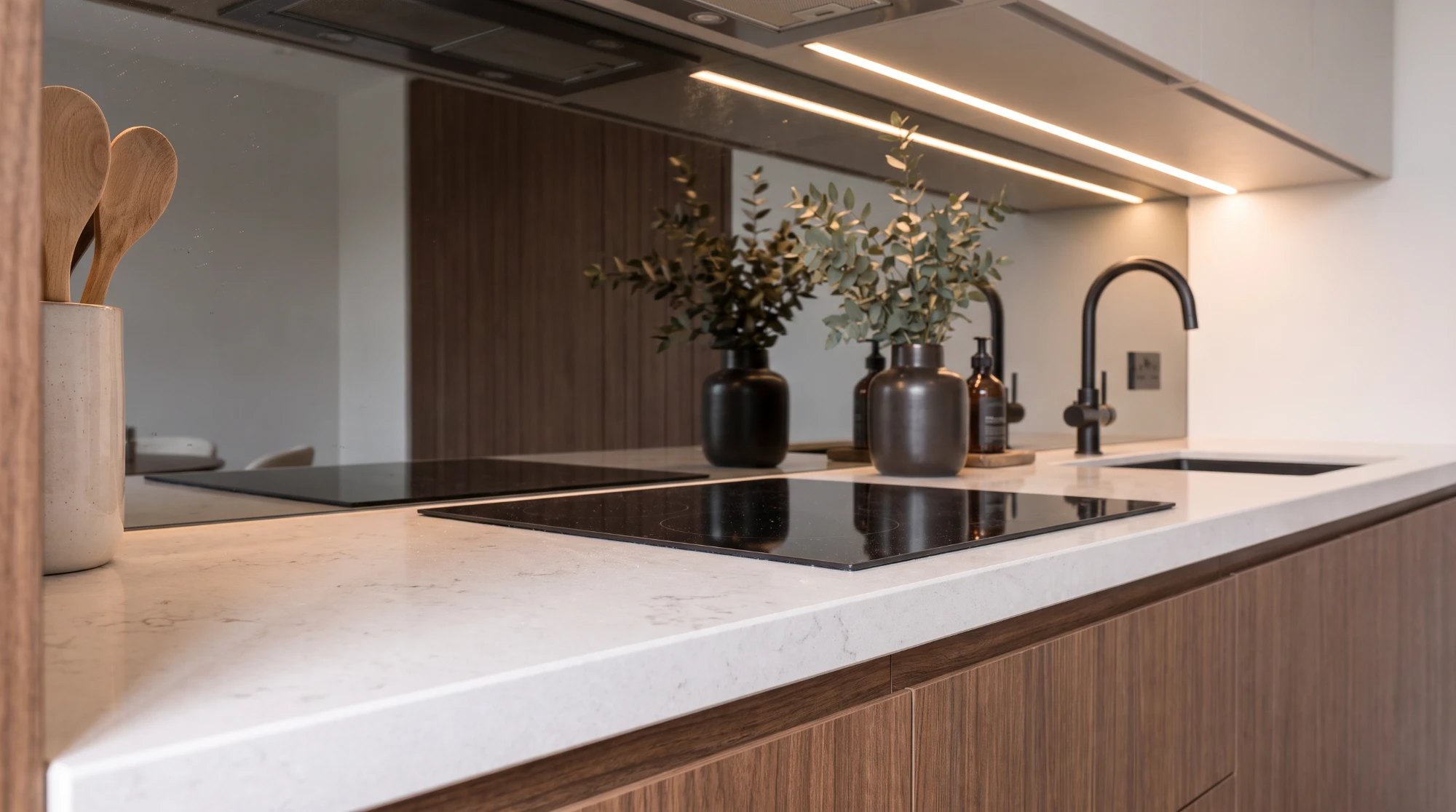 Grey toughened mirror splashback behind a hob