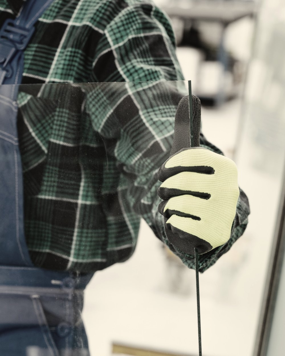 Handling a sheet of toughened glass in our Windsor workshop